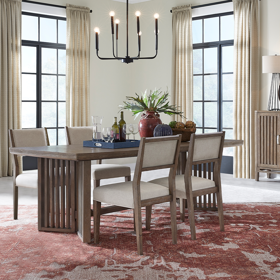 Brightly lit room with pink carpet dining table and four chairs