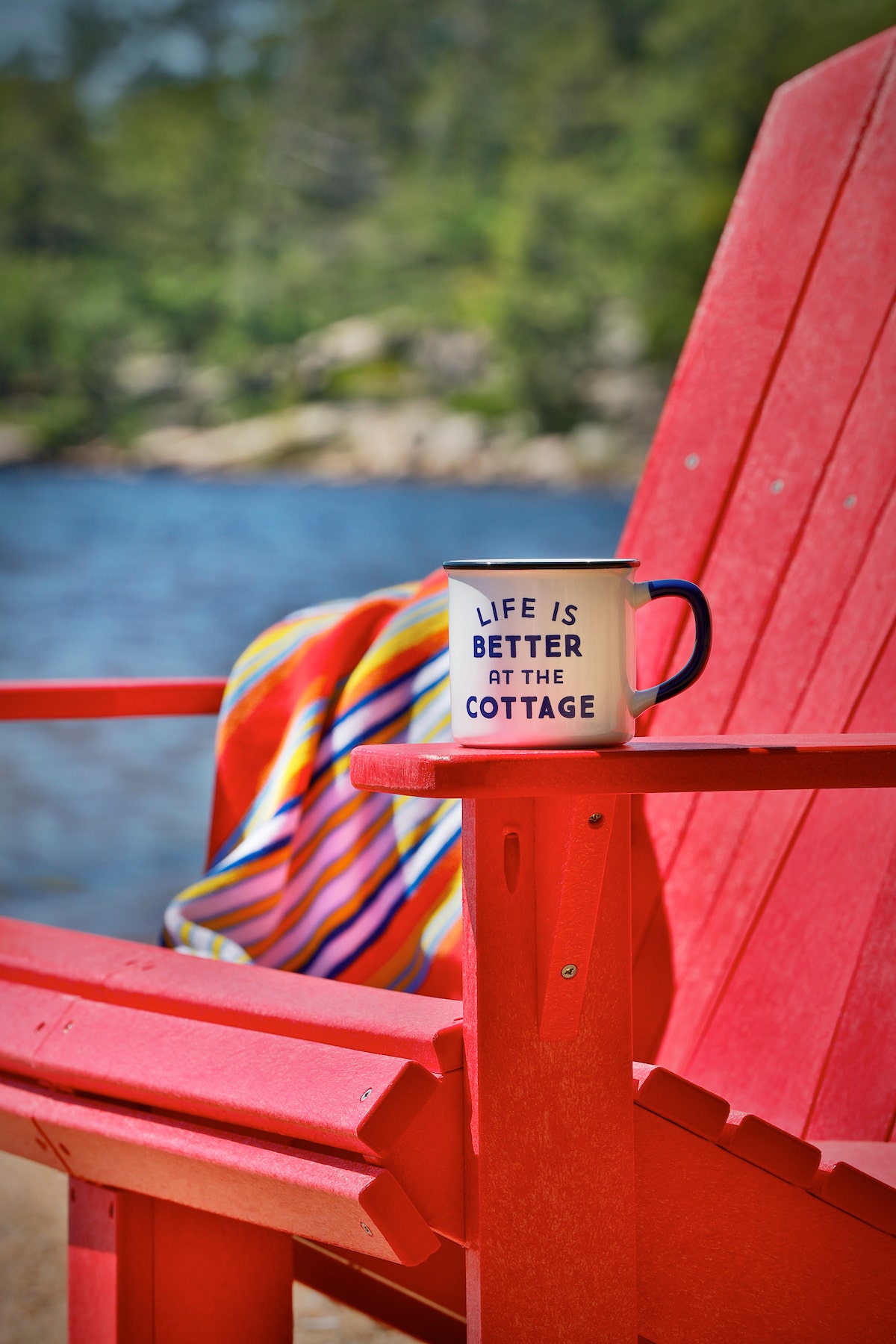 mug sitting on arm of red patio chair